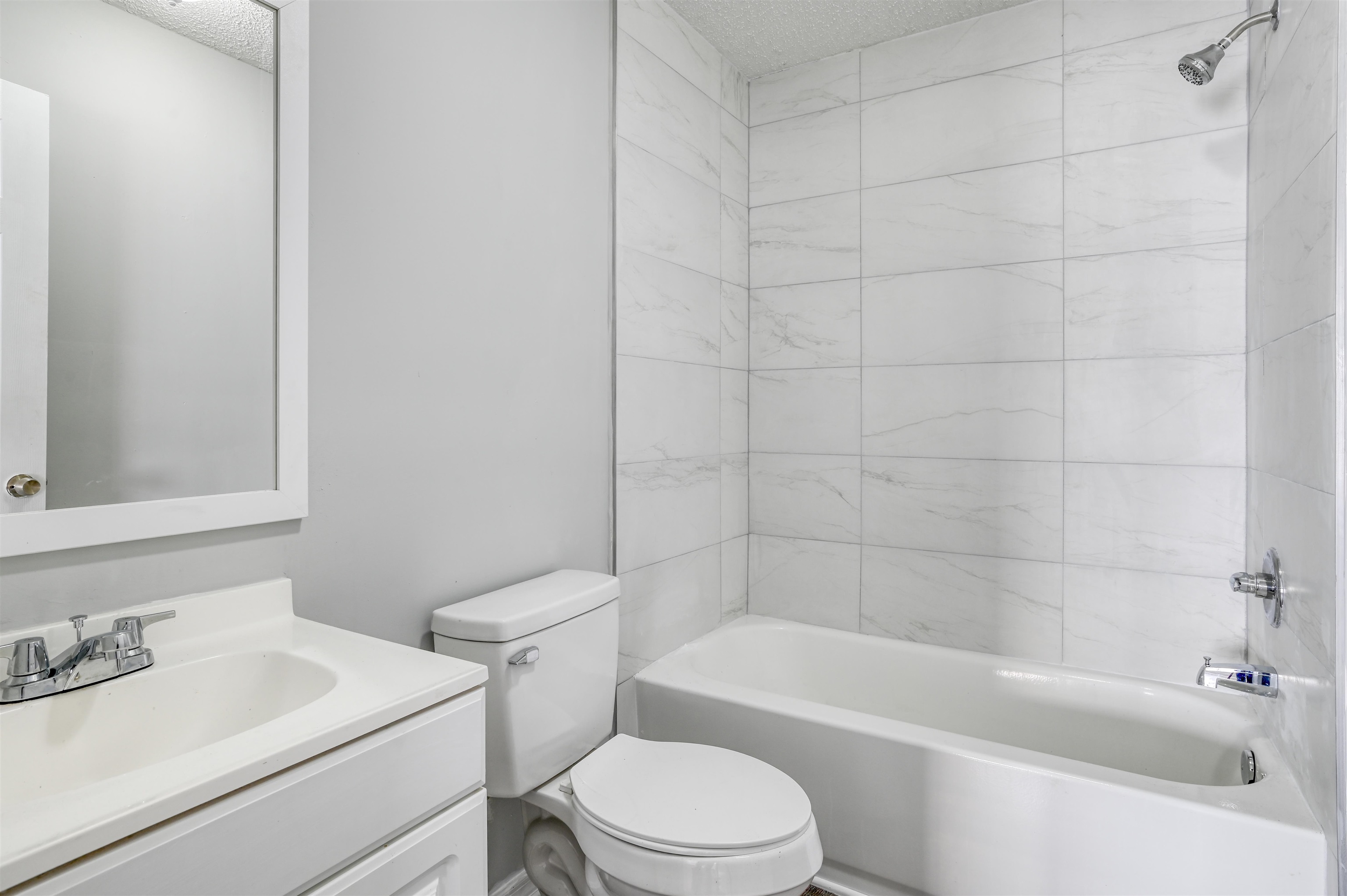 4661 Second Avenue St. Augustine, FL 32095 - Photo 21 of 26 a white toilet sitting next to a bath tub