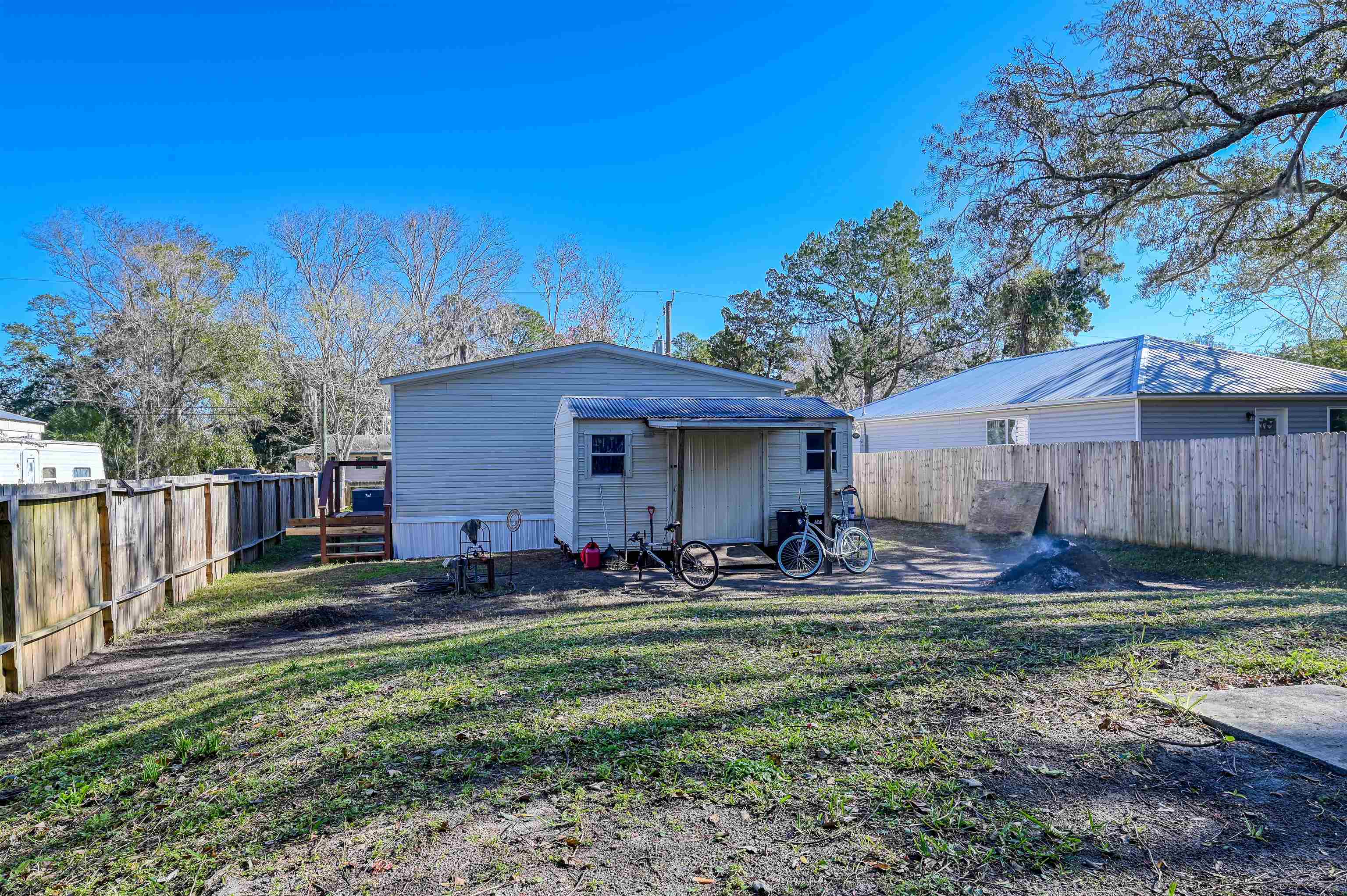 4661 Second Avenue St. Augustine, FL 32095 - Photo 25 of 26 a backyard of a house with barbeque oven table and chairs