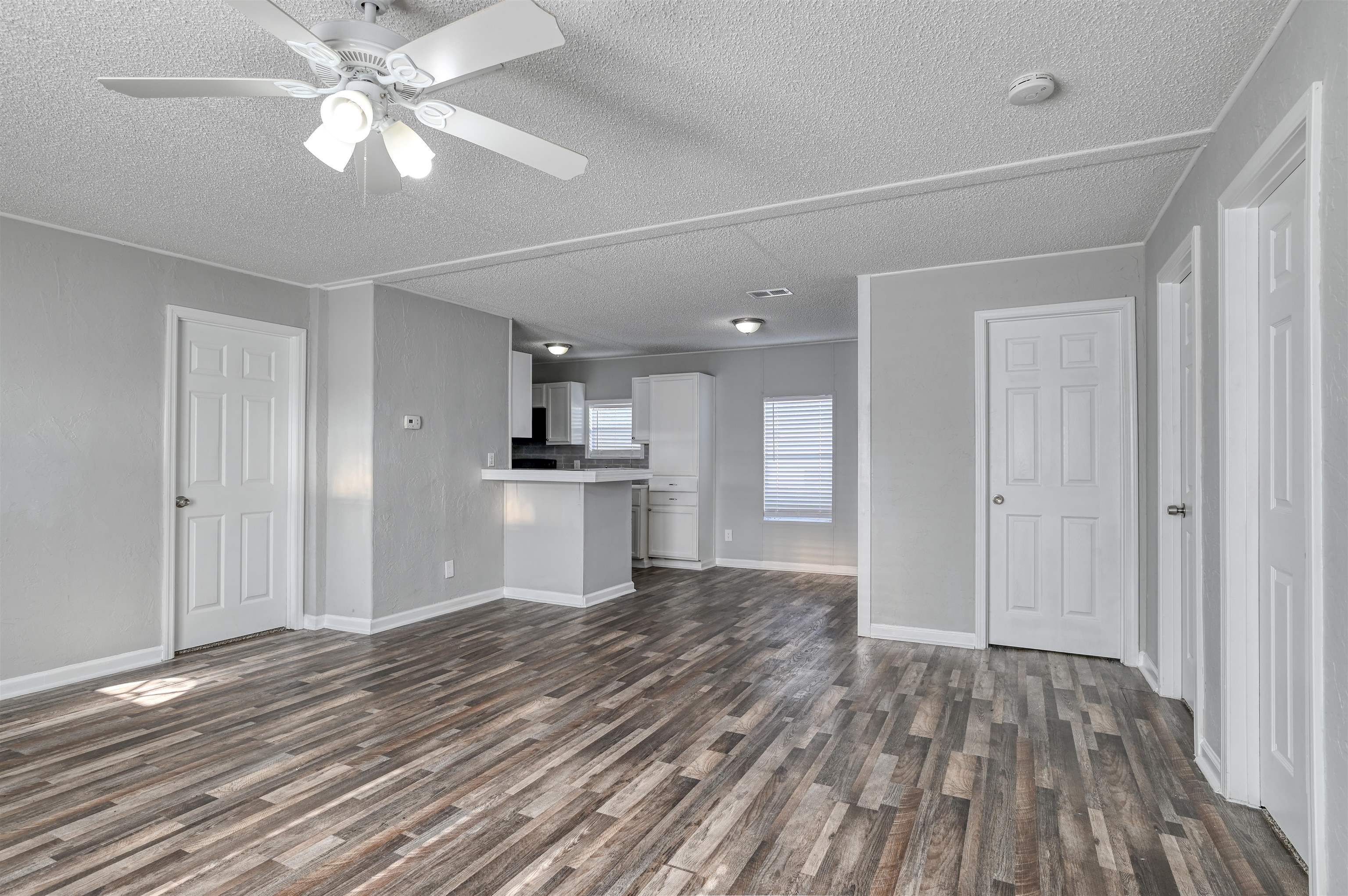 4661 Second Avenue St. Augustine, FL 32095 - Photo 6 of 26 a view of kitchen and empty room with wooden floor