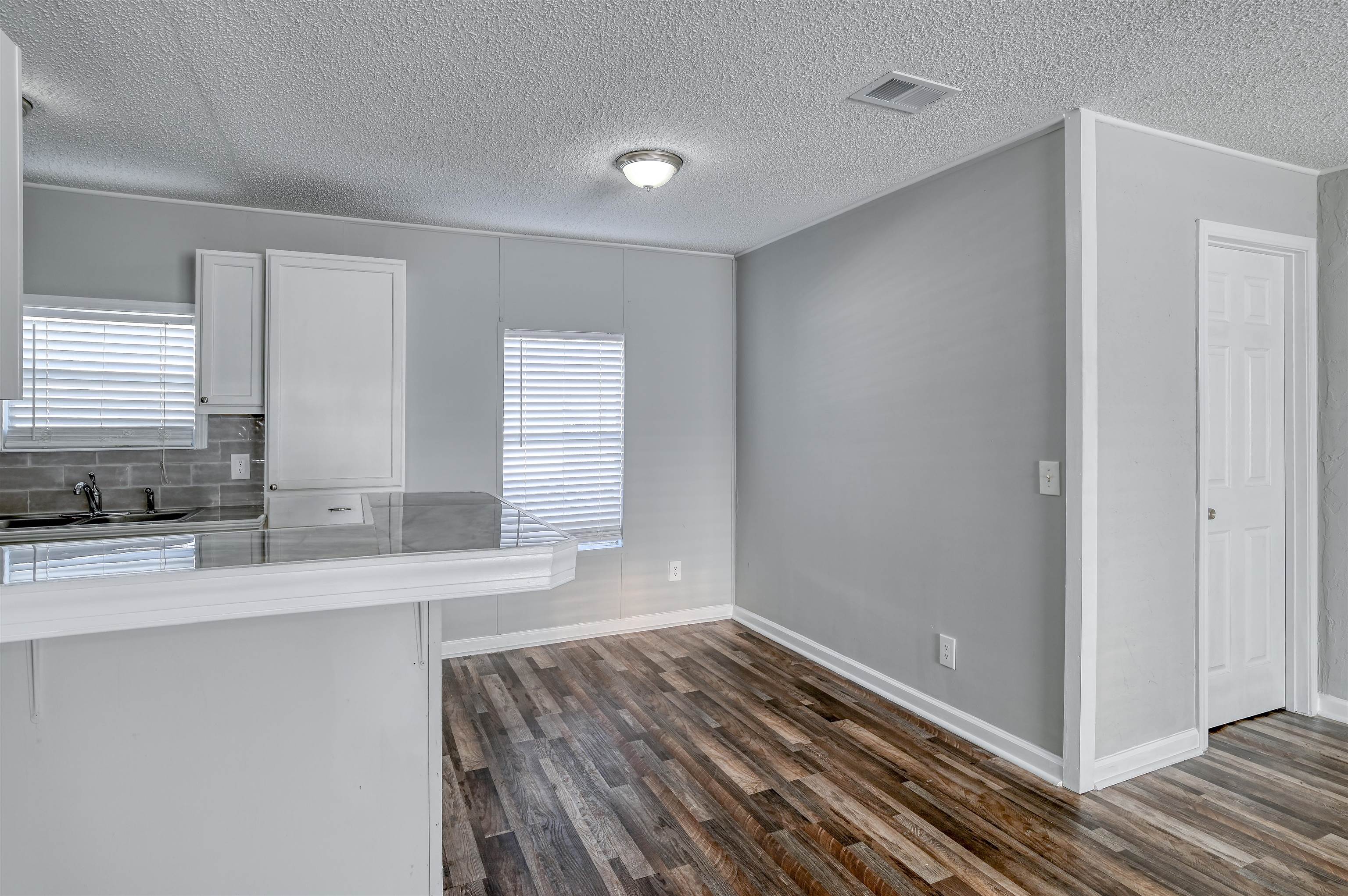 4661 Second Avenue St. Augustine, FL 32095 - Photo 8 of 26 a view of a kitchen cabinets a sink and dishwasher with wooden floor
