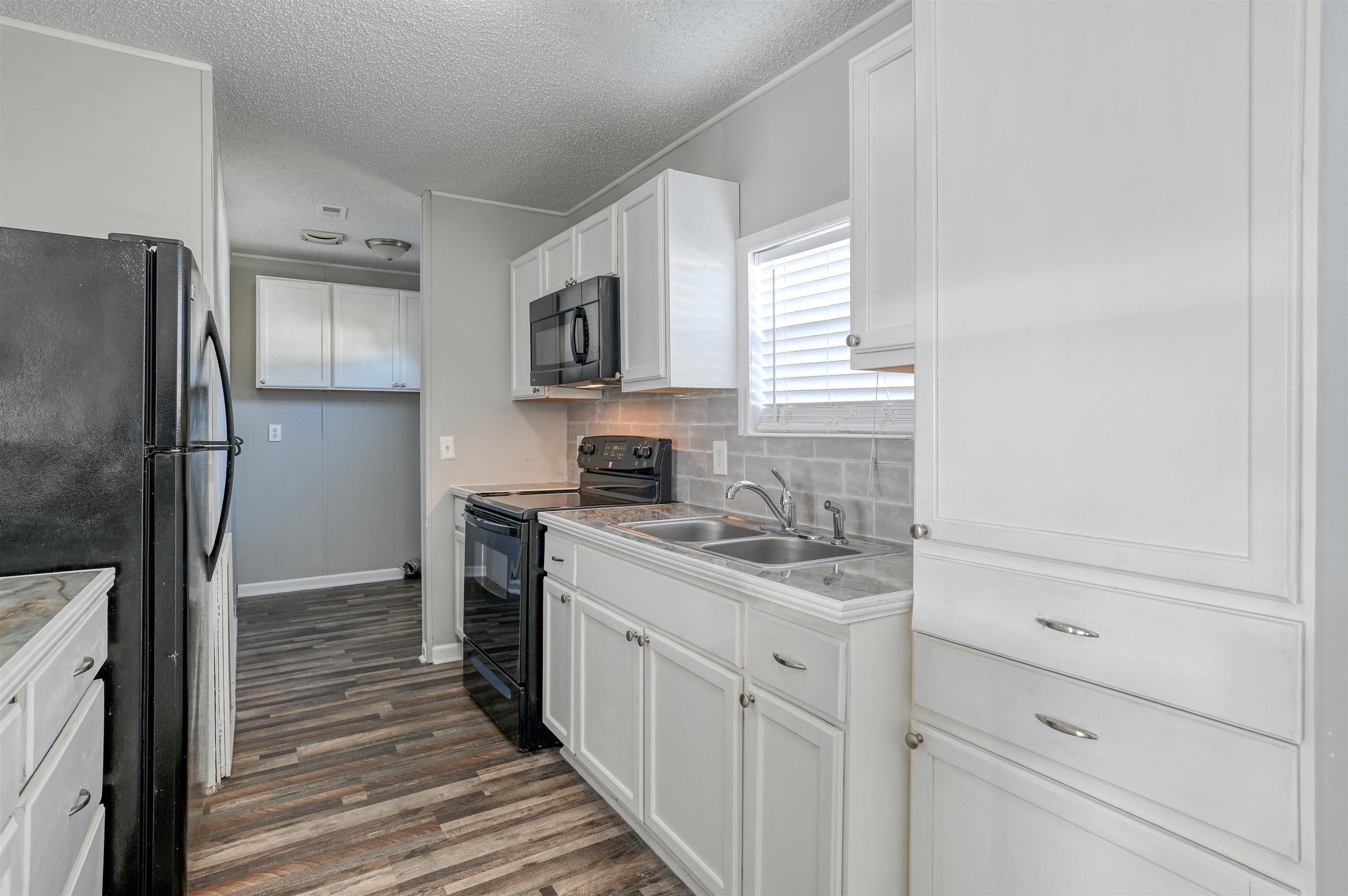 4661 Second Avenue St. Augustine, FL 32095 - Photo 10 of 26 a kitchen with a sink stove and refrigerator