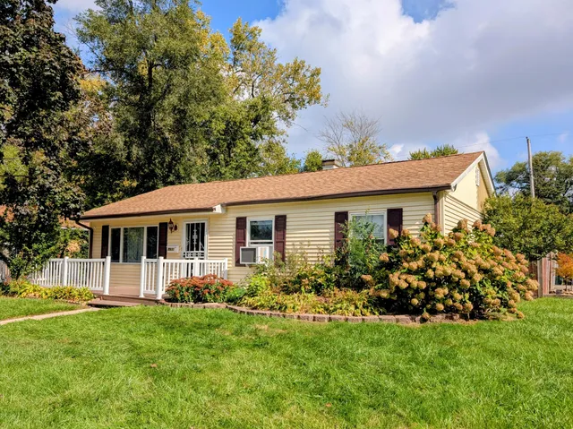 a front view of house with yard and green space