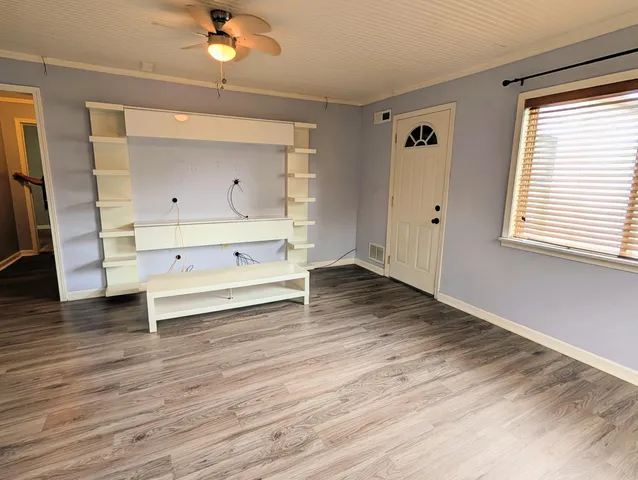 a view of room with wooden floor and staircase