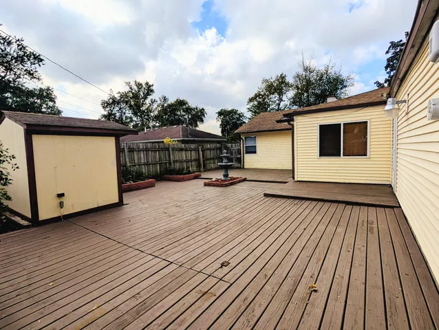 a view of a house with wooden deck