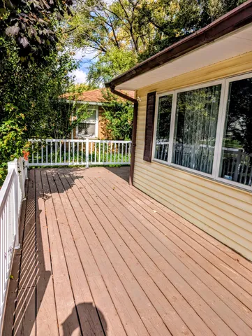 a view of balcony with deck and wooden floor