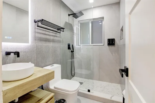 a bathroom with a sink toilet and shower
