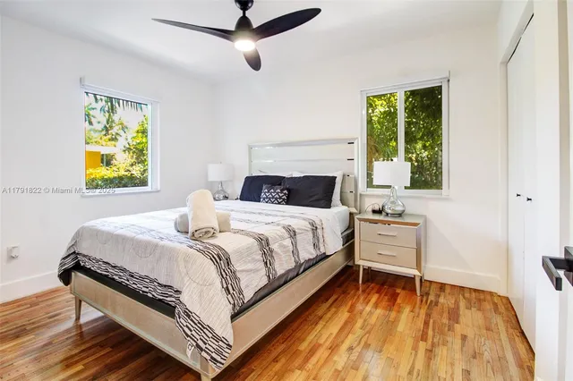 a bedroom with a bed and painting on the wall