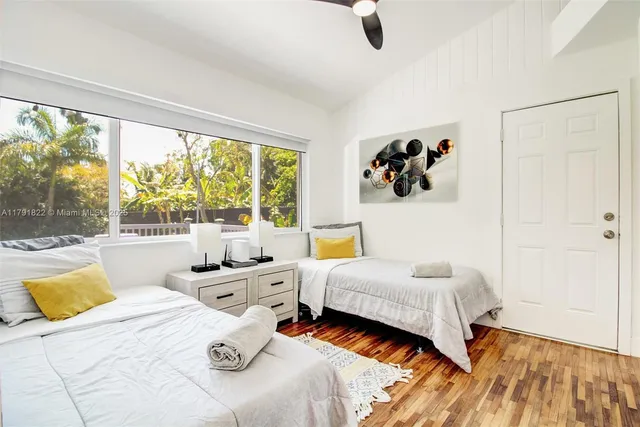 a bedroom with a bed and a large window