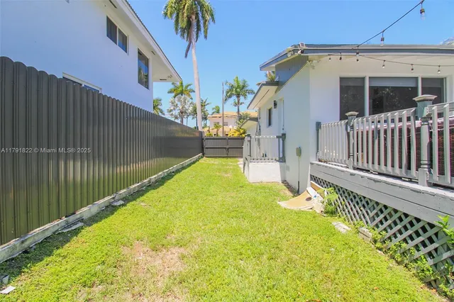 an aerial view of a house with swimming pool and large trees