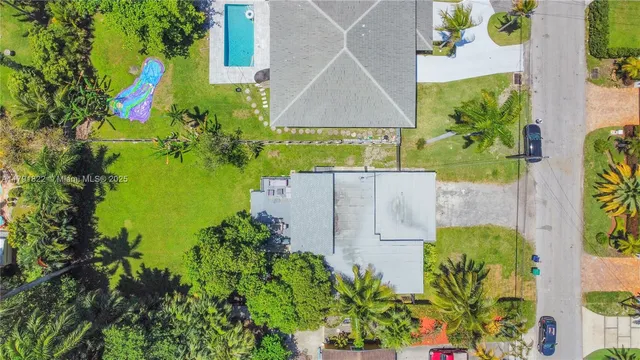 an aerial view of a house with a yard and garden
