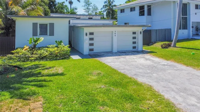 a view of a house with a yard and plants
