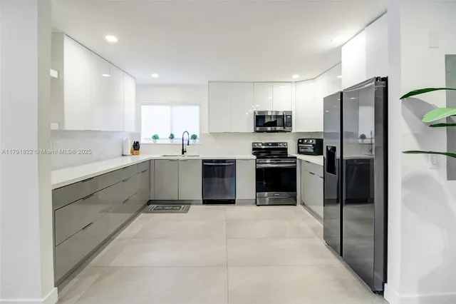 a kitchen with a sink stainless steel appliances and cabinets