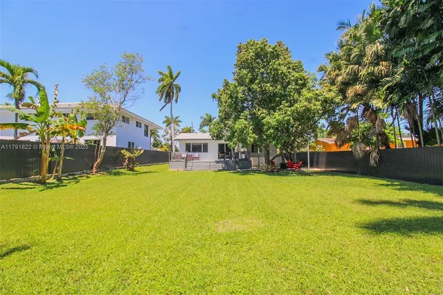 a front view of a house with a yard and swimming pool