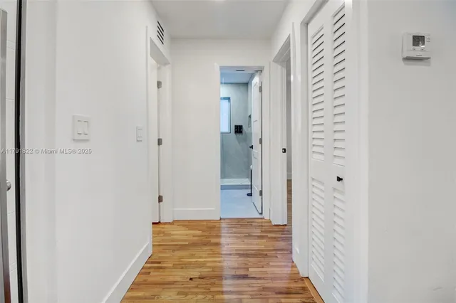 a view of a bathroom from a hallway