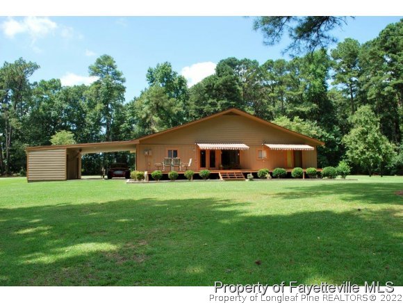 7371 Sherrill Baggett Road Dunn, NC 28334 - Photo 1 of 25 a house view with a garden space
