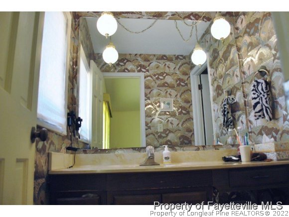 7371 Sherrill Baggett Road Dunn, NC 28334 - Photo 15 of 25 a bathroom with a sink and a mirror