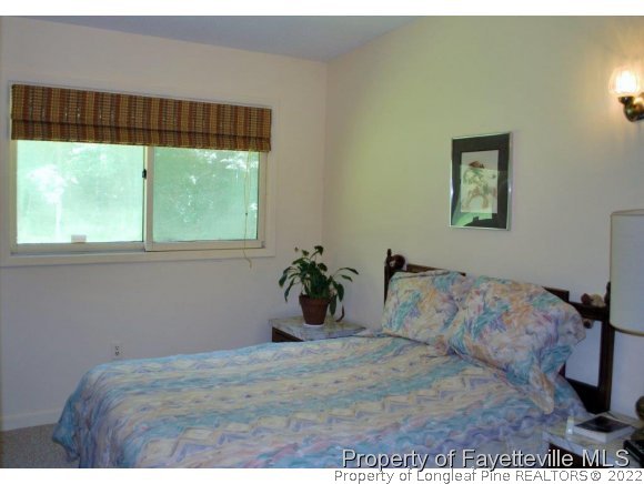 7371 Sherrill Baggett Road Dunn, NC 28334 - Photo 18 of 25 a bedroom with a bed and a window