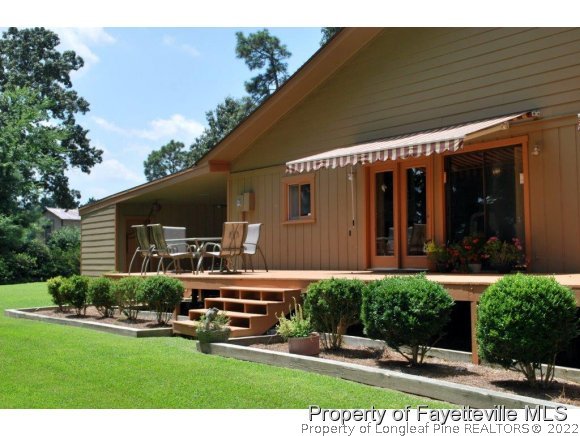 7371 Sherrill Baggett Road Dunn, NC 28334 - Photo 2 of 25 a view of a house with backyard sitting area and garden