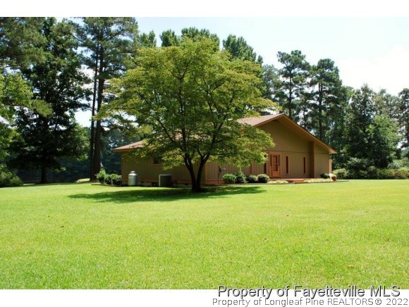 7371 Sherrill Baggett Road Dunn, NC 28334 - Photo 22 of 25 a view of a house with a yard and basketball court