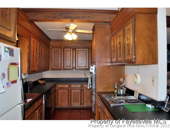 7371 Sherrill Baggett Road Dunn, NC 28334 - Photo 7 of 25 a kitchen with a sink and cabinets