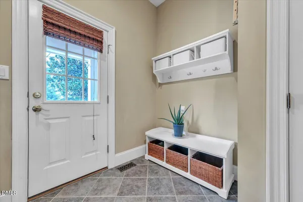 a spacious bedroom with a bed and a chandelier