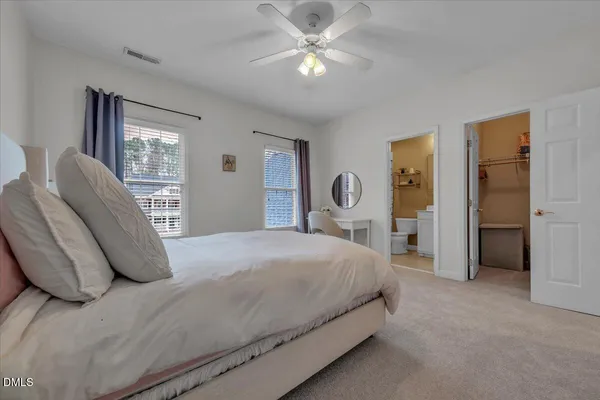 a view of an empty room with kitchen and a window
