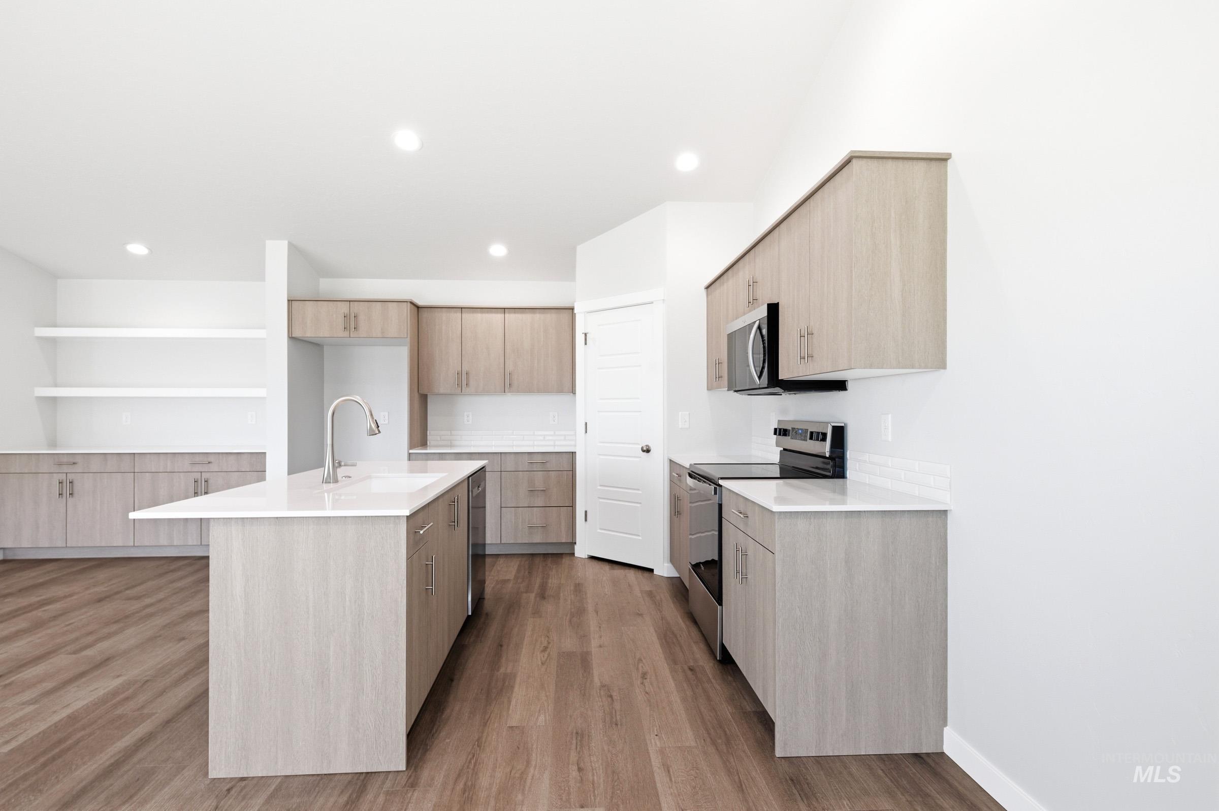 12877 Decatur Street Nampa, ID 83651 - Photo 8 of 22 Kitchen featuring wood-finish flooring, recessed lighting, and light wood-tone cabinetry