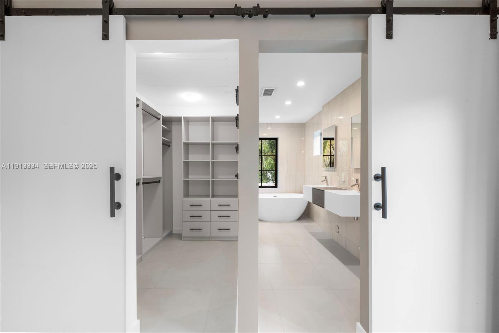 151 Northeast 43rd Street Miami, FL 33137 - Photo 11 of 51 a view of a walk in closet and bedroom