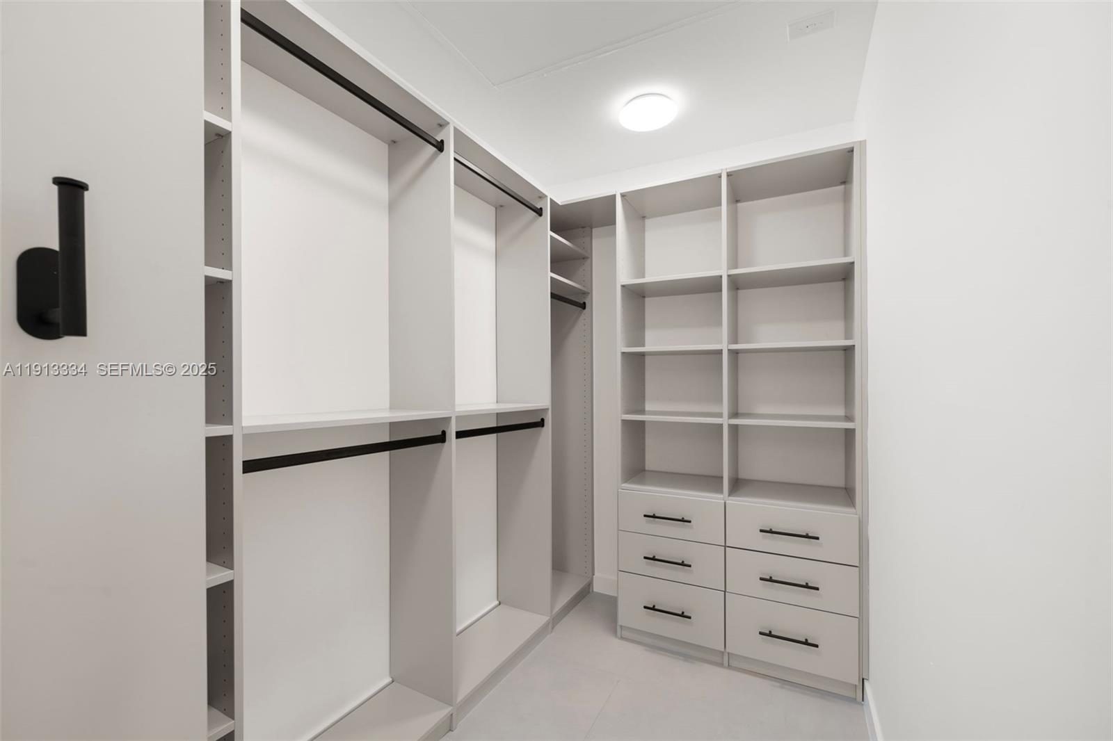 151 Northeast 43rd Street Miami, FL 33137 - Photo 12 of 51 a view of walk in closet with empty racks