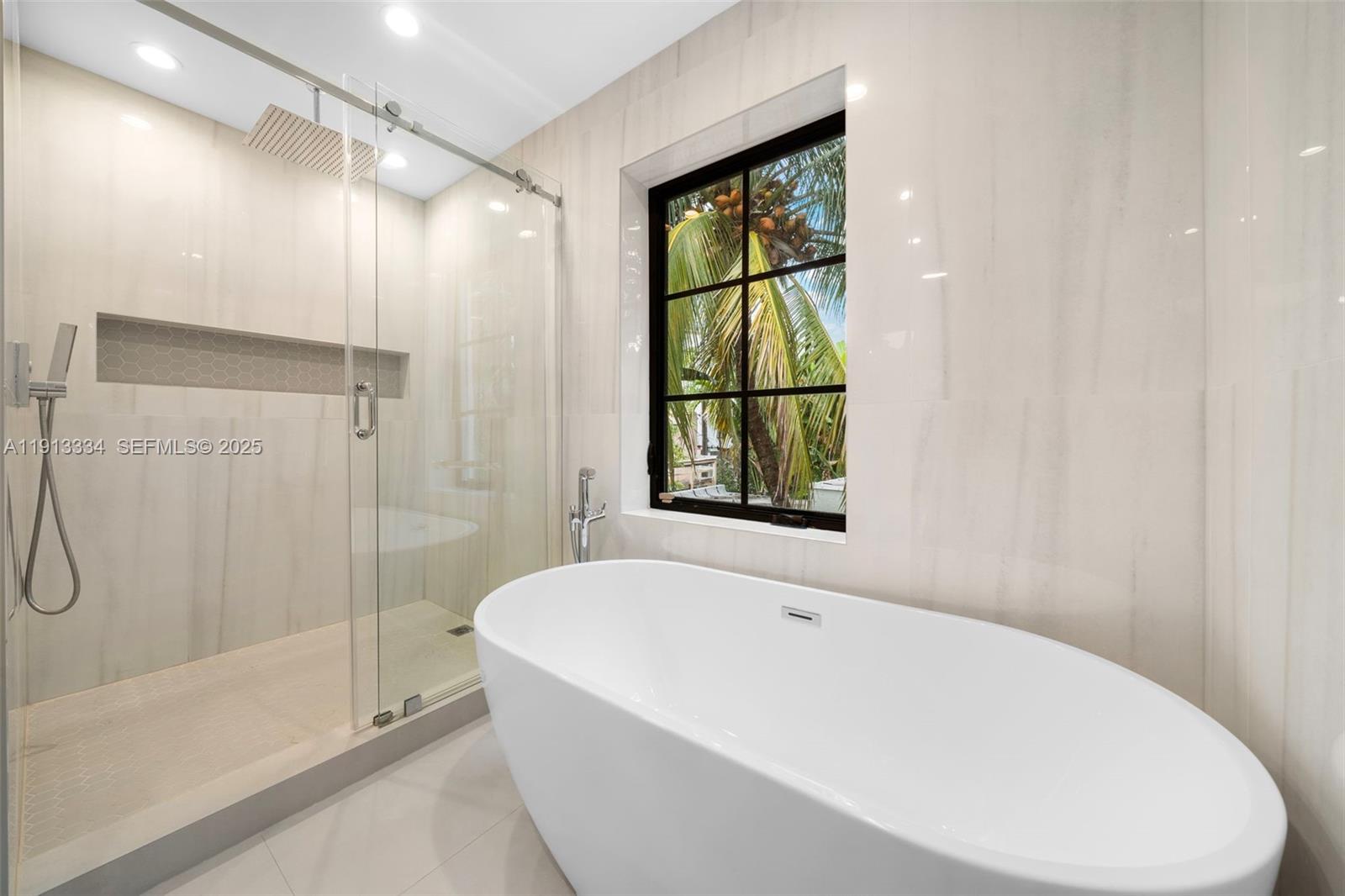 151 Northeast 43rd Street Miami, FL 33137 - Photo 15 of 51 a white bath tub sitting next to a shower