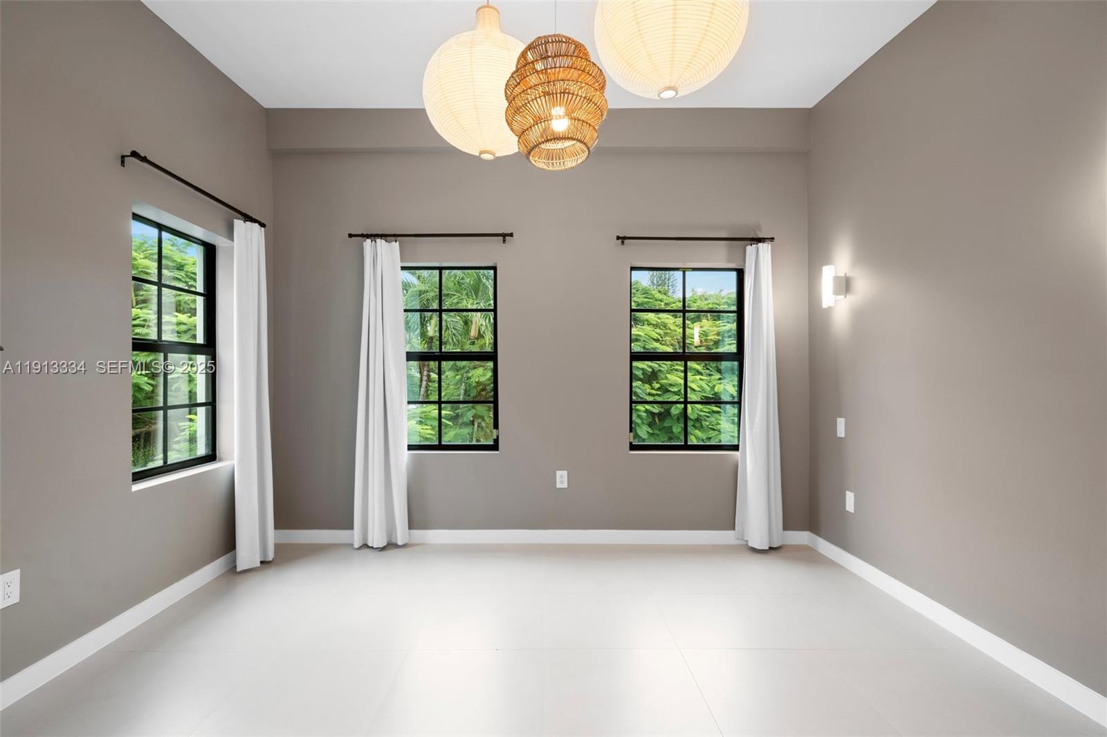 151 Northeast 43rd Street Miami, FL 33137 - Photo 17 of 51 an empty room with windows and entrance