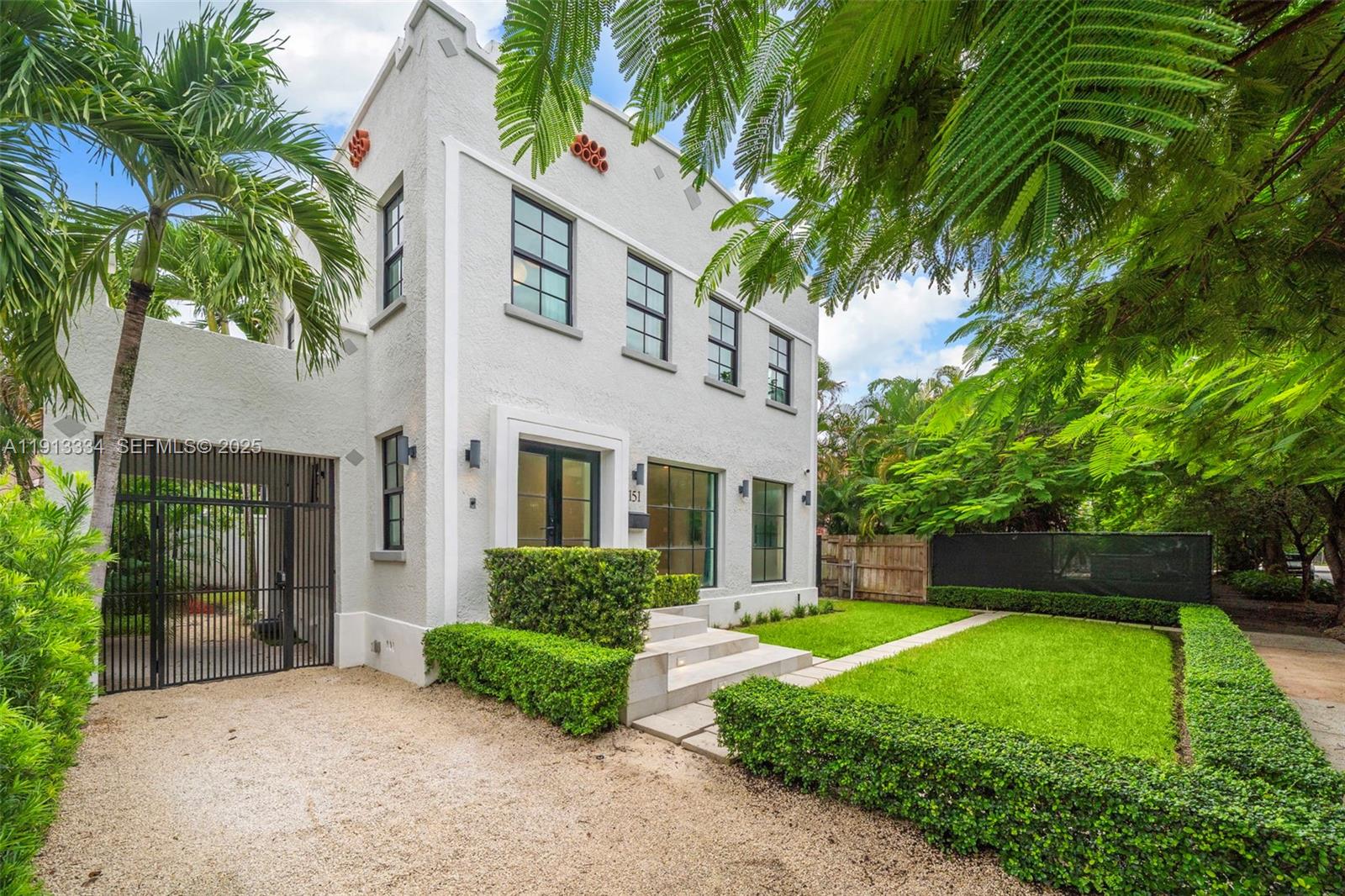151 Northeast 43rd Street Miami, FL 33137 - Photo 2 of 51 a front view of a house with garden