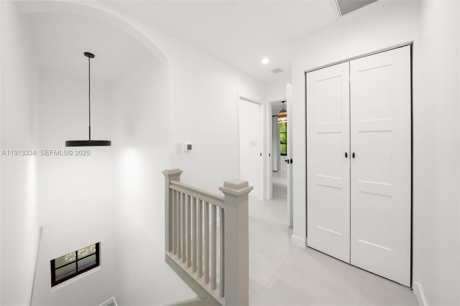 151 Northeast 43rd Street Miami, FL 33137 - Photo 22 of 51 a view of a hallway with a small space