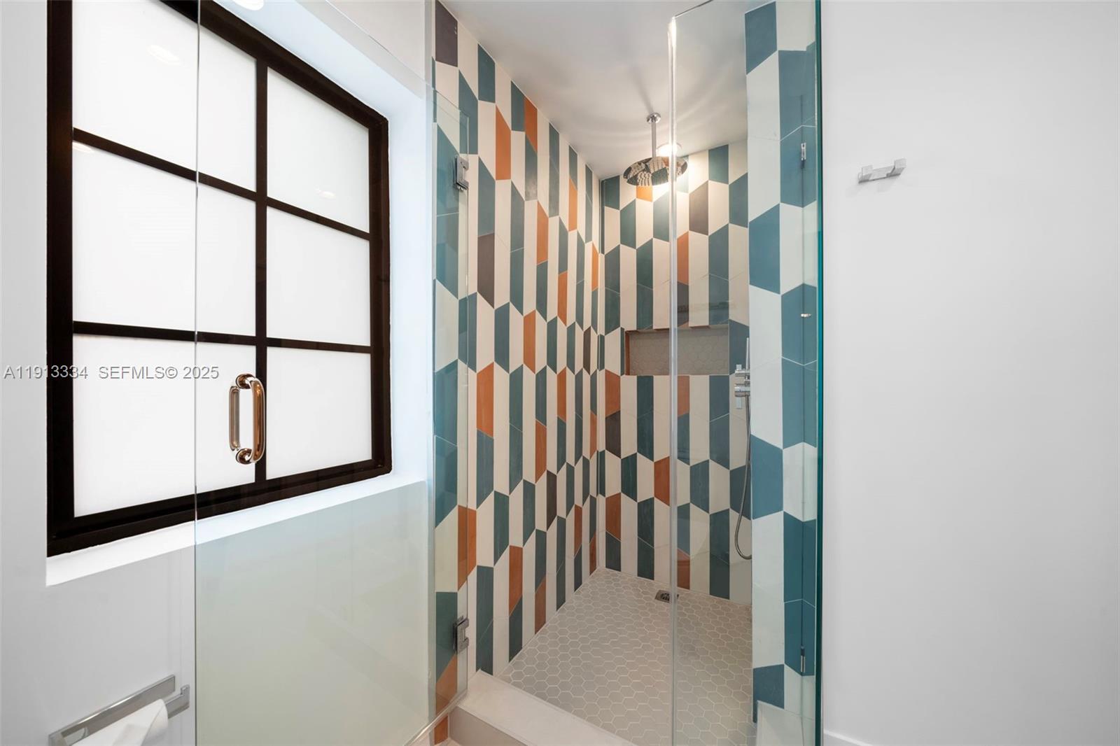 151 Northeast 43rd Street Miami, FL 33137 - Photo 24 of 51 a view of staircase with lots of frames on wall