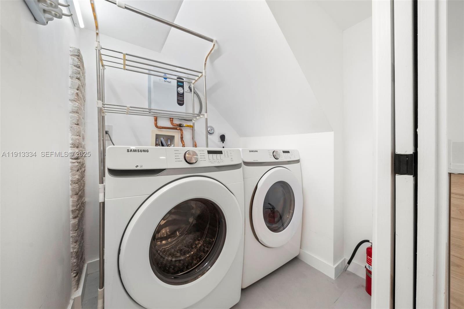 151 Northeast 43rd Street Miami, FL 33137 - Photo 25 of 51 a utility room with dryer and washer