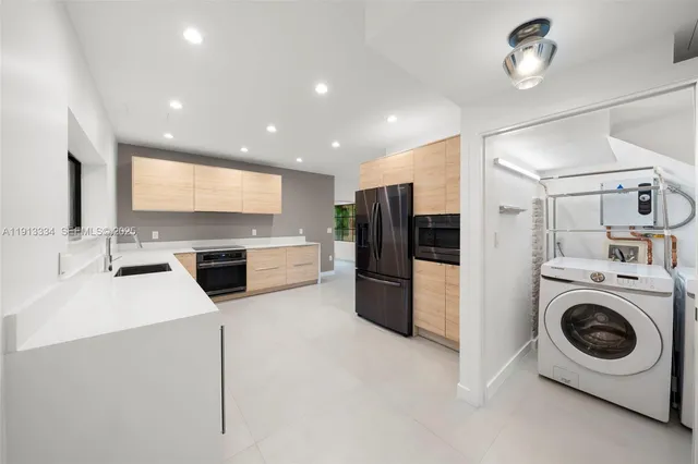a kitchen with refrigerator a washer and dryer