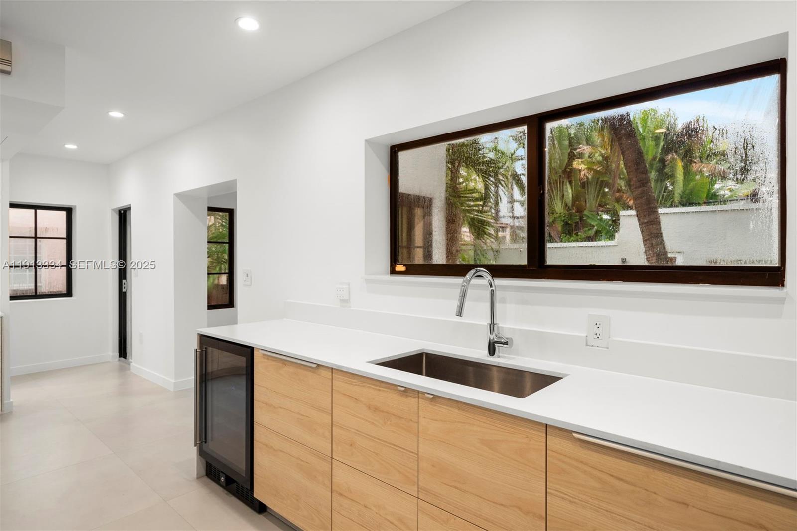 151 Northeast 43rd Street Miami, FL 33137 - Photo 30 of 51 a kitchen with a sink and large window