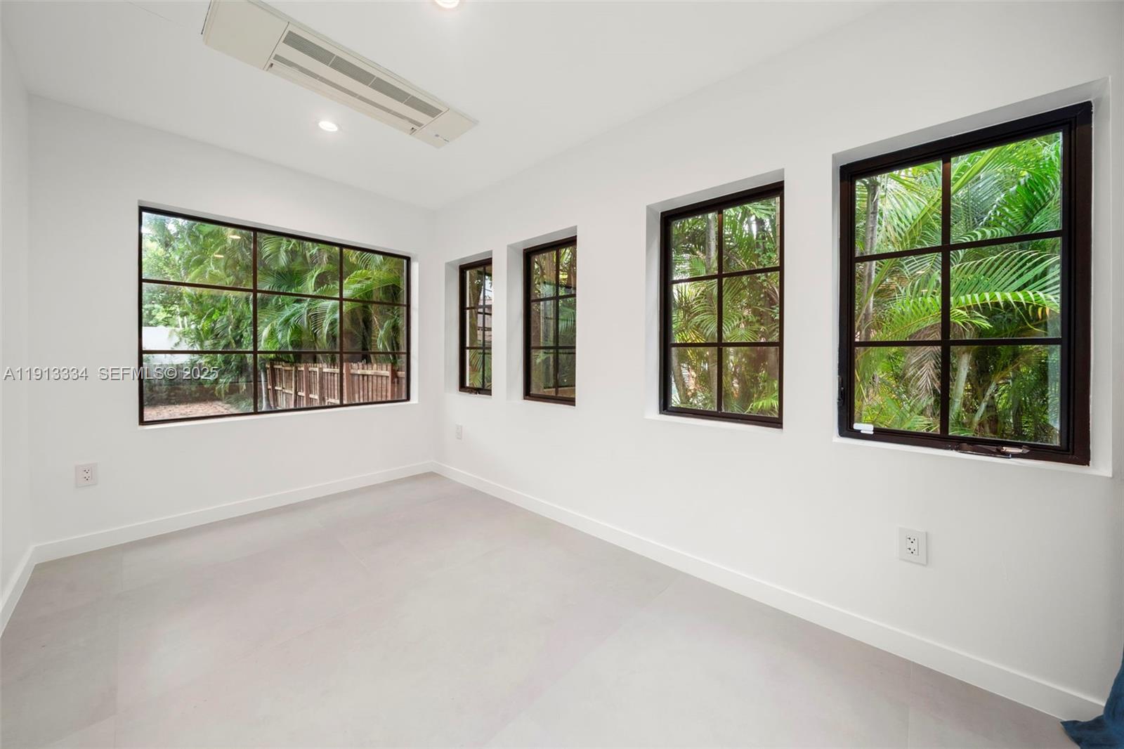 151 Northeast 43rd Street Miami, FL 33137 - Photo 35 of 51 an empty room with large windows