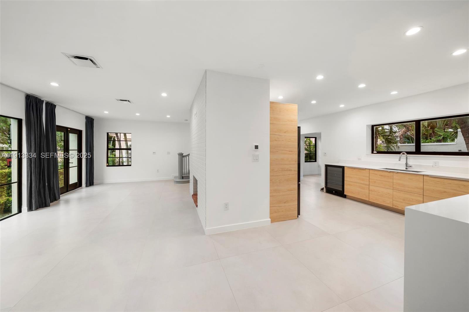 151 Northeast 43rd Street Miami, FL 33137 - Photo 37 of 51 a view of a kitchen with a refrigerator and a stove top oven