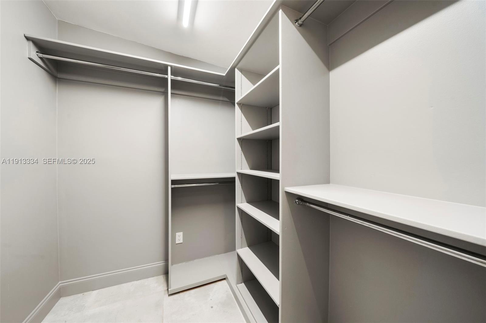 151 Northeast 43rd Street Miami, FL 33137 - Photo 47 of 51 a view of walk in closet with empty racks