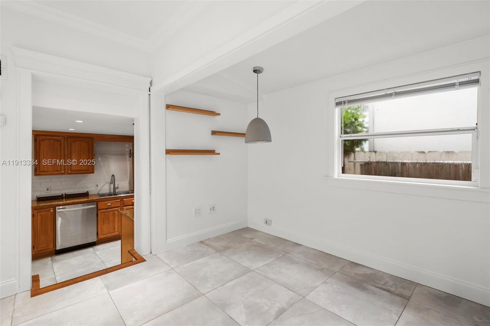 151 Northeast 43rd Street Miami, FL 33137 - Photo 50 of 51 an empty room with a kitchen and a window
