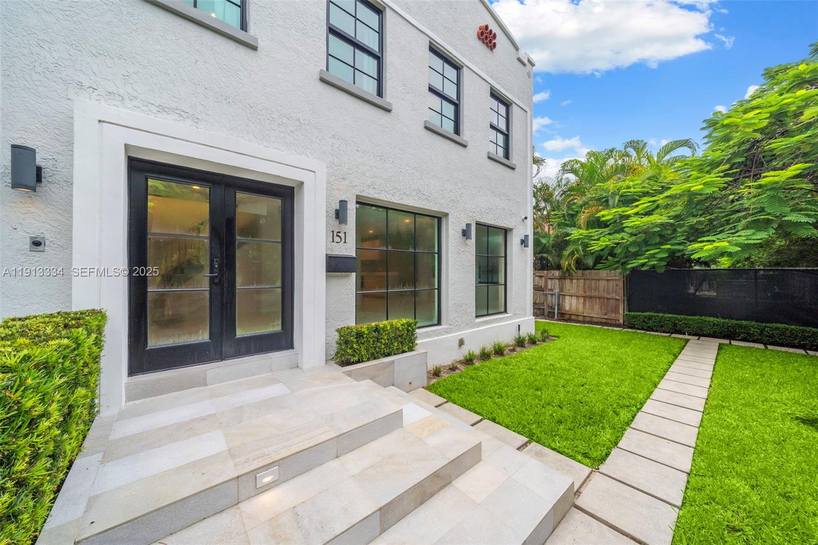151 Northeast 43rd Street Miami, FL 33137 - Photo 7 of 51 a front view of a house with a yard