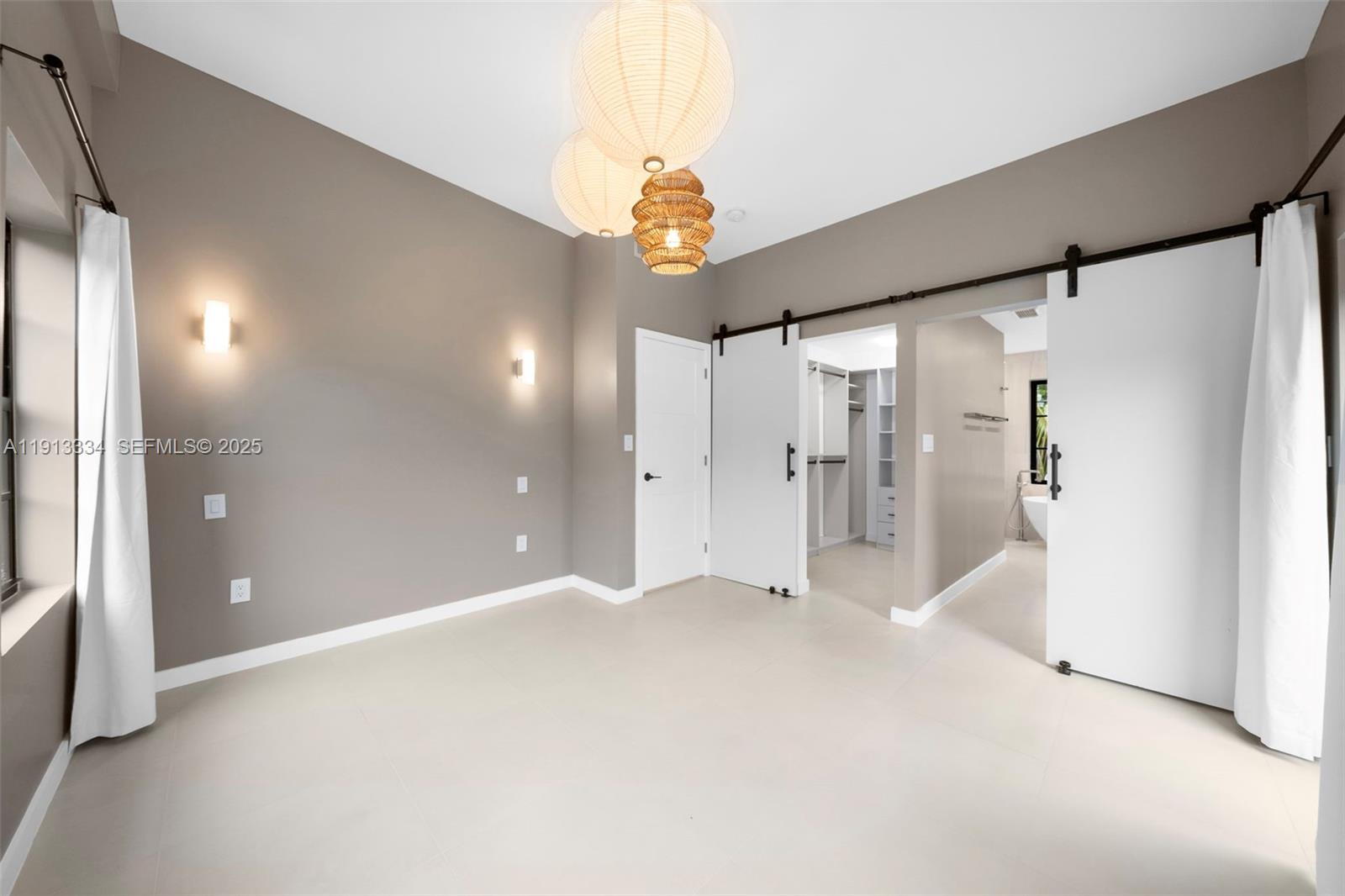 151 Northeast 43rd Street Miami, FL 33137 - Photo 10 of 51 a view of an empty room with a chandelier