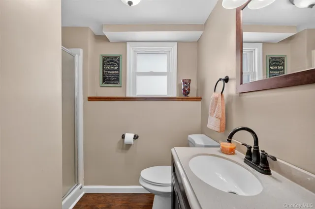 a bathroom with a sink a toilet and mirror