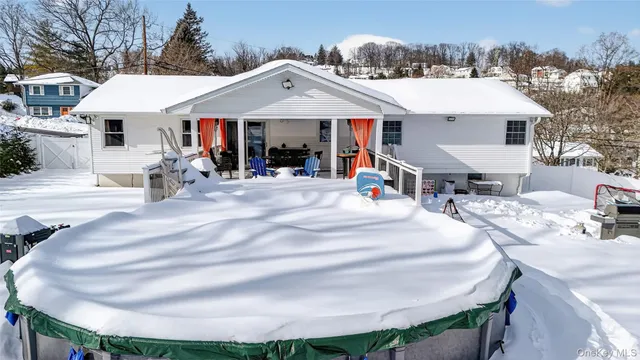 a front view of a house with sitting area and garden
