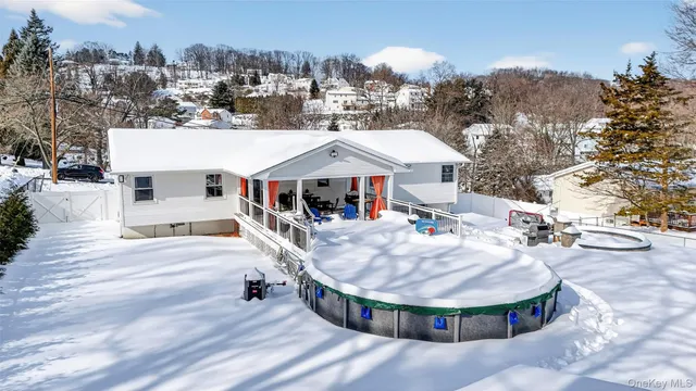 a view of a house with roof deck and sitting area