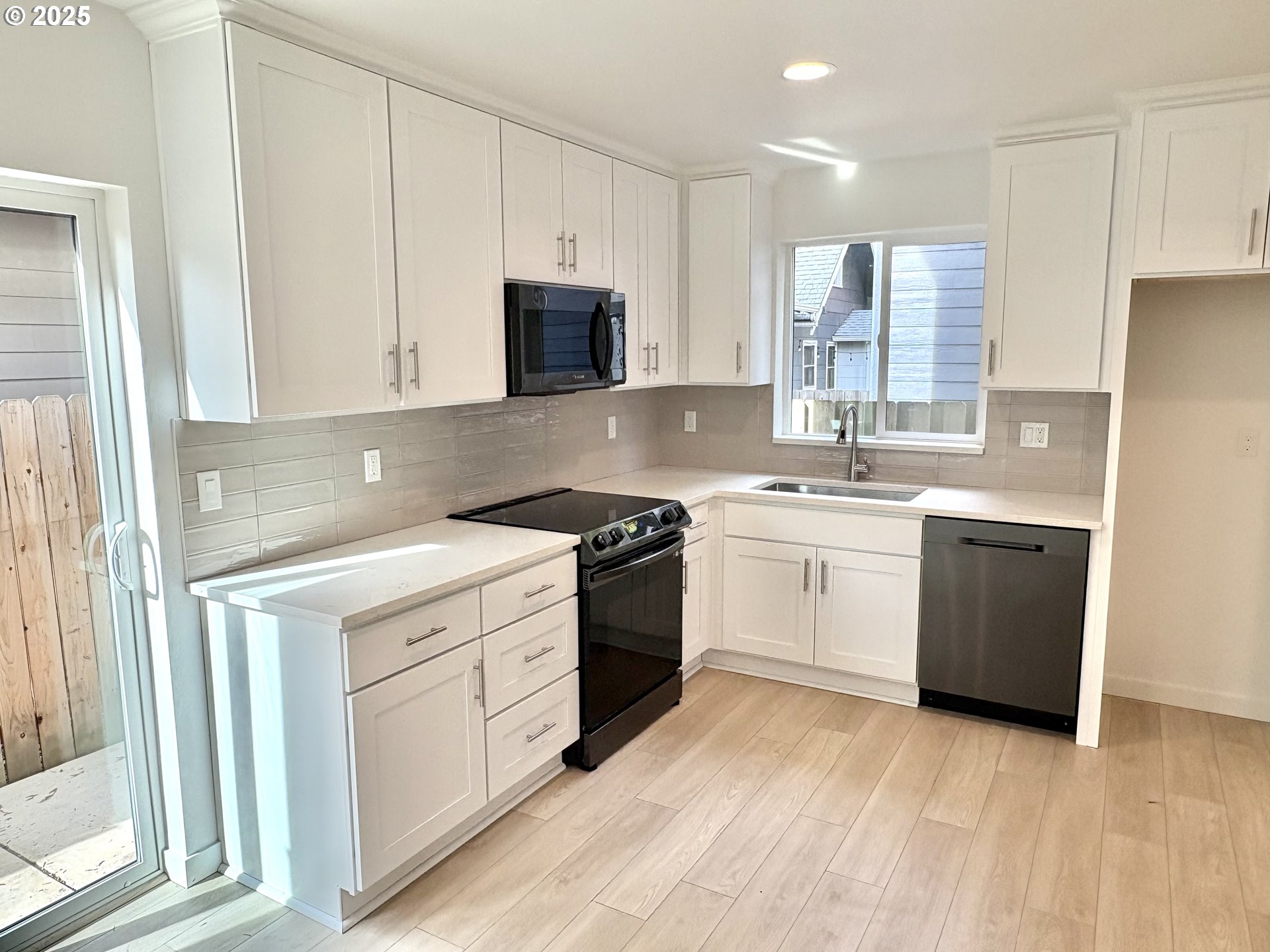 6 Northeast 74th Avenue, Unit C Portland, OR 97213 - Photo 2 of 9 a kitchen with a white stove top oven and white cabinets