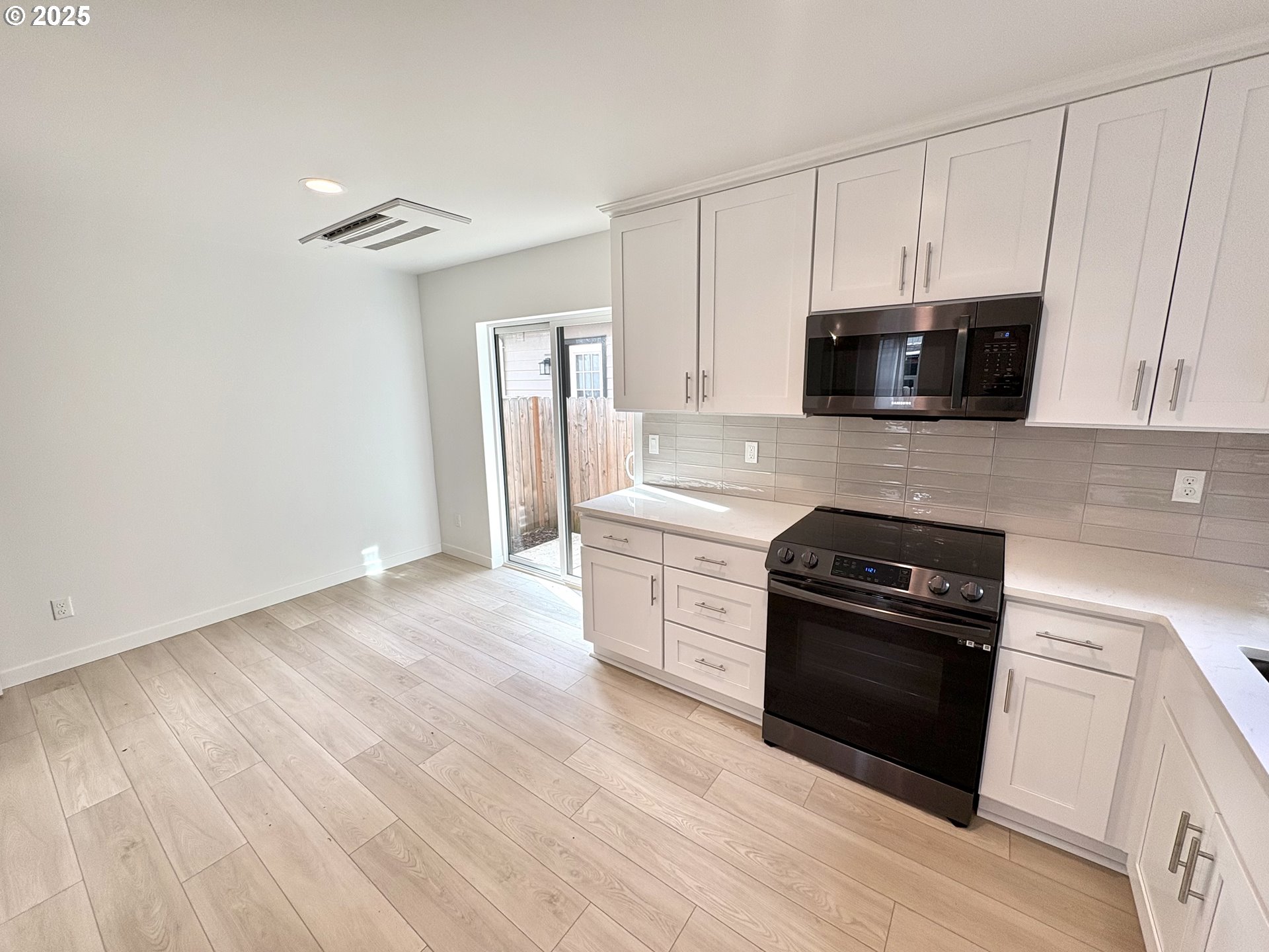 6 Northeast 74th Avenue, Unit C Portland, OR 97213 - Photo 3 of 9 a kitchen with stainless steel appliances a stove microwave and sink