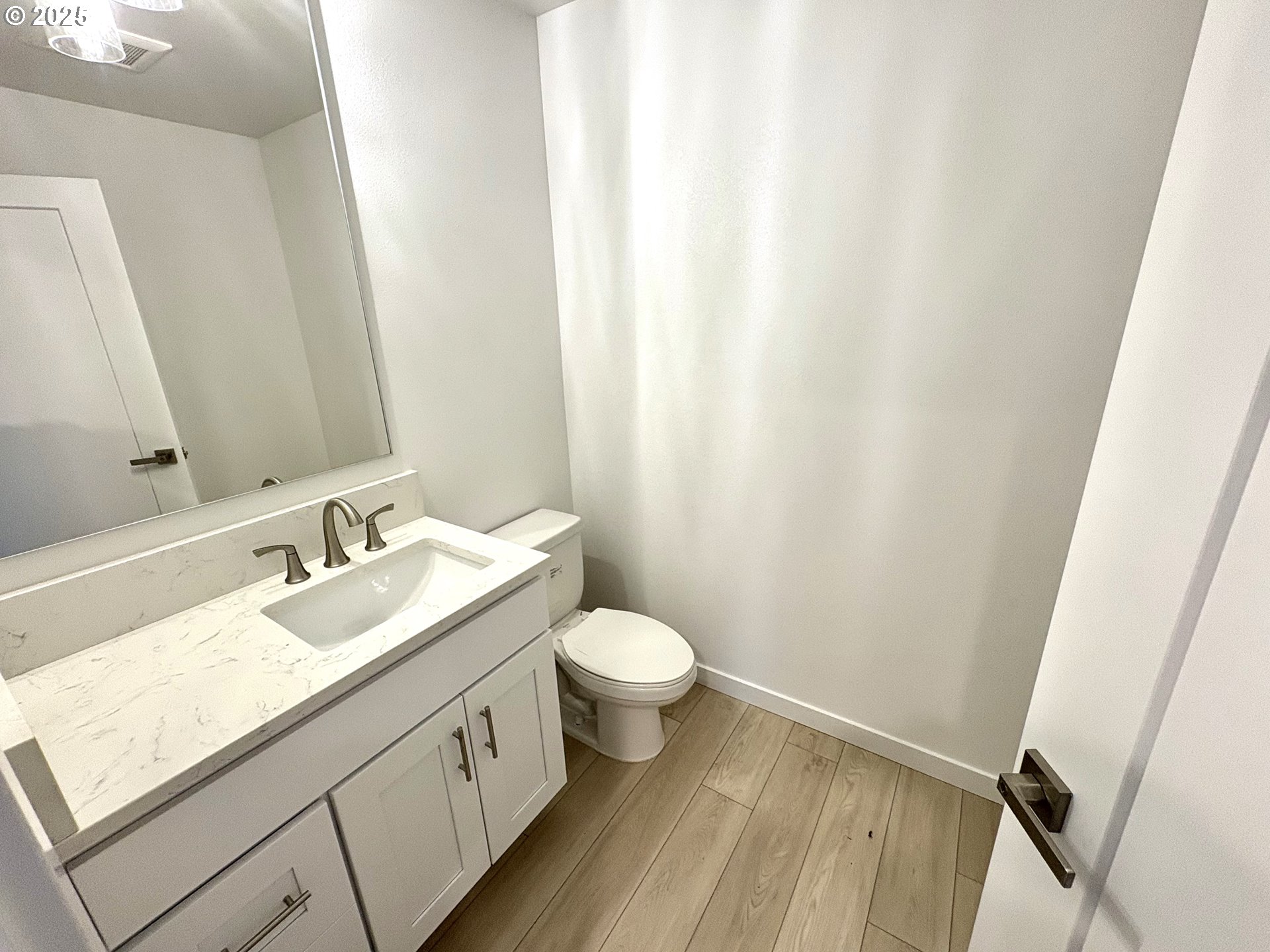 6 Northeast 74th Avenue, Unit C Portland, OR 97213 - Photo 4 of 9 a bathroom with a granite countertop sink toilet and mirror