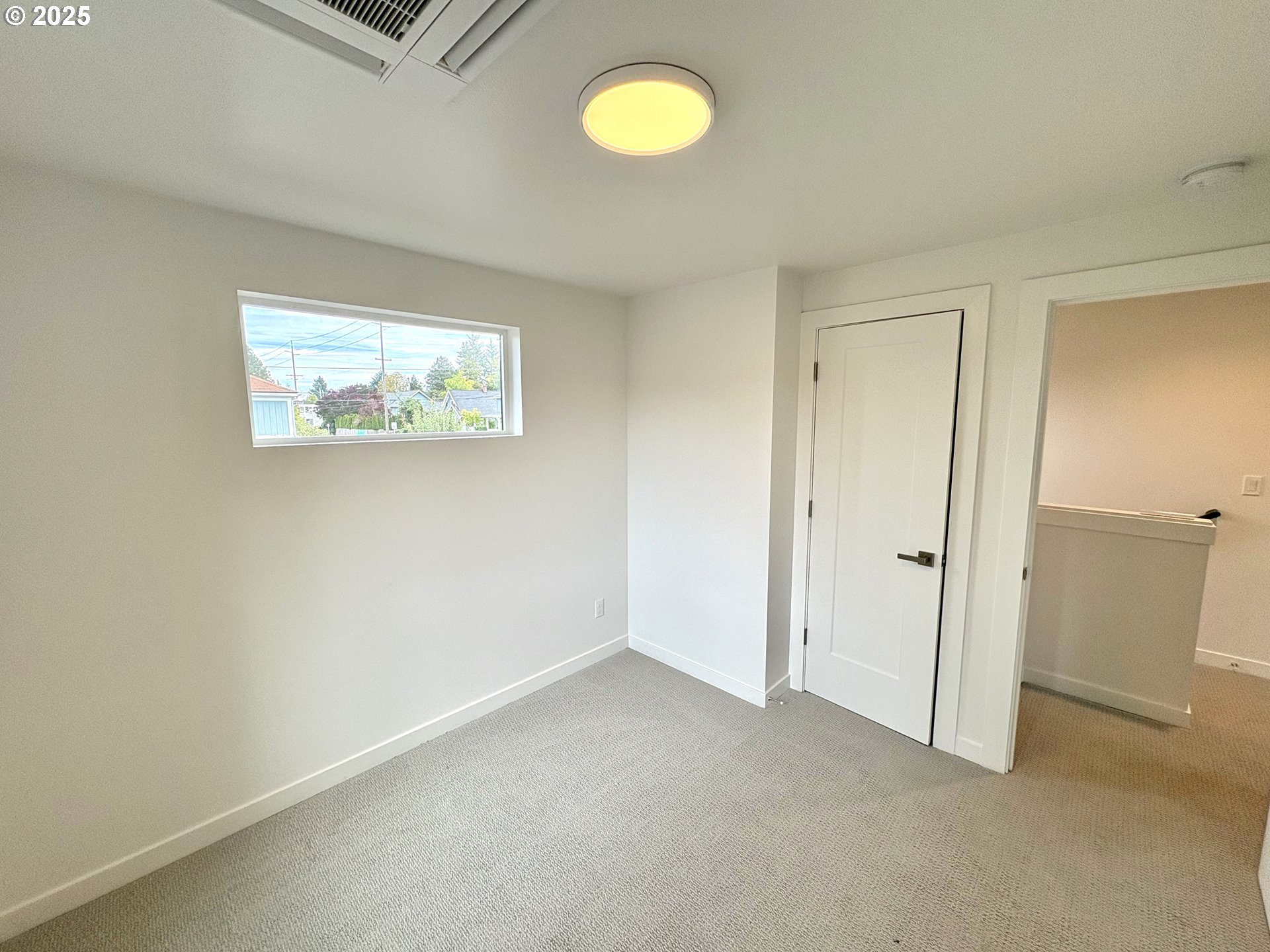 6 Northeast 74th Avenue, Unit C Portland, OR 97213 - Photo 5 of 9 an empty room with a fan